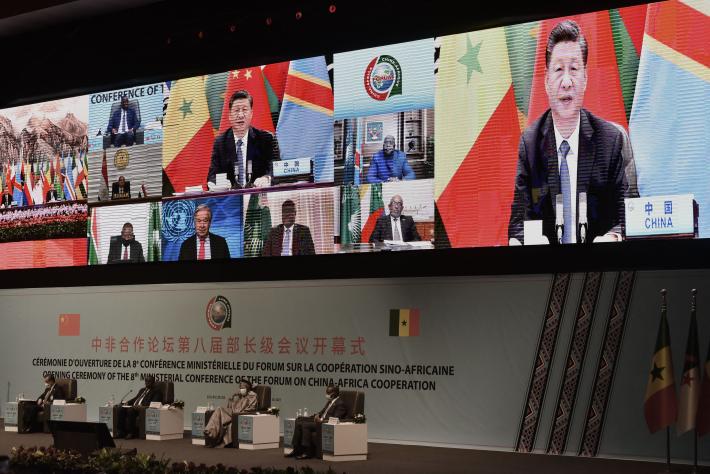 Dakar, Senegal – Nov. 29, 2021 – Chinese President Xi Jinping (on the screen) delivers a speech during the China-Africa Cooperation (FOCAC) meeting in Dakar. Photo by Seyllou/AFP via Getty Images.