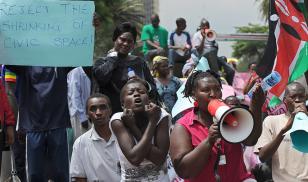 Civil activists demonstrate in Nairobi outside parliament buildings over two recent parliamentary bills they say will curb hard-won freedoms and muzzle government critics. Credit: TONY KARUMBA/AFP/Getty Images.