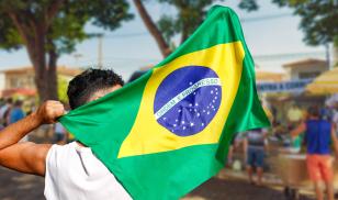 man holding brazilian flag 