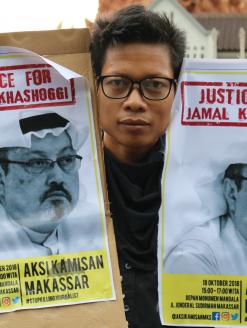Humanitarian activists hold a poster with a picture of Jamal Khashoggi, a journalist who was killed in Turkey. Makassar, Indonesia. 18 October 2018. Editorial credit: Herwin Bahar / Shutterstock.com   
