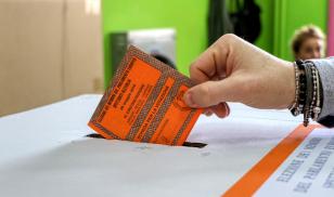 A man inserts the inserts a voted ballot into the ballot box. Puglia, Italy. 26 May 2019. Editorial Credit: Editorial credit: Massimo Todaro / Shutterstock.com