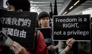 protester holds sign that says freedom is a right not a privilege hong kong china