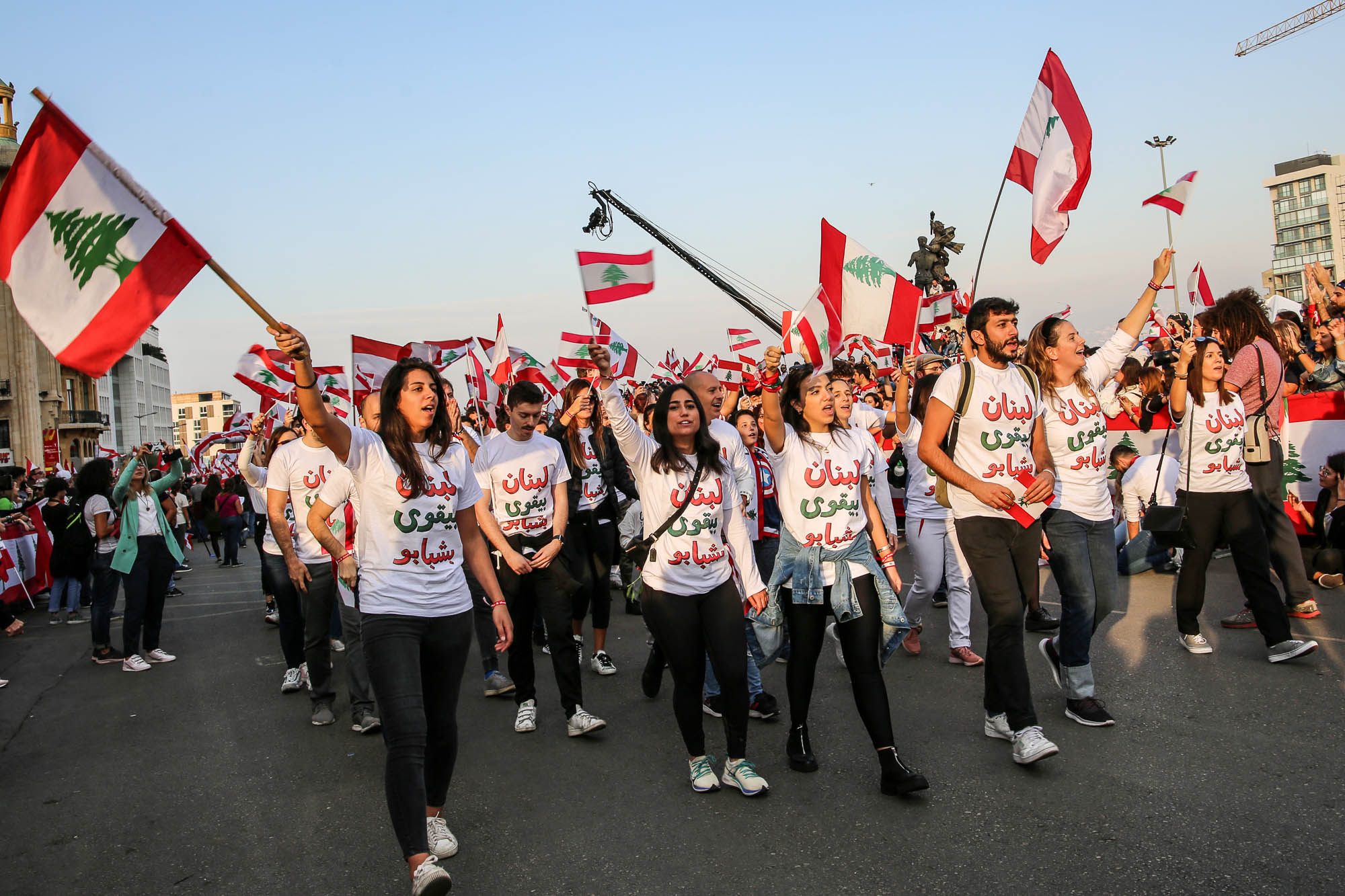 Beirut, Lebanon - November 22, 2019: Lebanese marching for Lebanon's Independence Day in a Civil Parade while protesting against the current government and corruption in the country. Editorial credit: Hiba Al Kallas / Shutterstock.com.