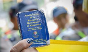 Detail of a copy of the Constitution of Venezuela. In the hands of a demonstrator against the government of Nicolás Maduro.  Venezuela.  Decmeber 2016. Editorial credit:  StringerAL / Shutterstock.com 