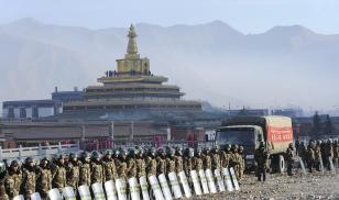 Chinese soldiers amass outside of Labrang Monastery in Gansu Province to prevent protests during Losar, the Tibetan lunar New Year festival, in February 2016 (Christophe Boisvieux/Getty Images)