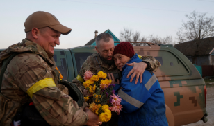 Valentyna Buhaiova embraces Ukrainian marines in her home village of Kyselivka, outside of Kherson, Ukraine, in November 2022. Ukrainian forces had recently retaken Kyselivka, liberating it from Russian occupation. (Image credit: Reuters/ Valentyn Ogirenko)