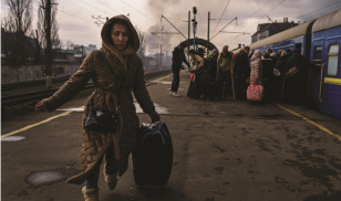 woman walking towards camera at train station